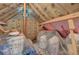 Spacious attic with exposed insulation and wooden beams, offering ample storage or potential for renovation at 1503 Pondside Ct, Summerville, SC 29485