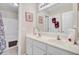 Bright bathroom showcasing double sinks, a large mirror, and a shower with a decorative floral curtain at 1503 Pondside Ct, Summerville, SC 29485