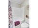 Bathroom with a bathtub and a purple floral shower curtain plus white toilet with chrome fixtures at 1503 Pondside Ct, Summerville, SC 29485