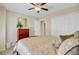 Neutral bedroom featuring a ceiling fan, closet, dresser with mirror and tan bedspread with a floral pattern at 1503 Pondside Ct, Summerville, SC 29485