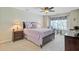 Comfortable bedroom featuring a ceiling fan, accent chair and luxurious bedding near a sunlit window at 1503 Pondside Ct, Summerville, SC 29485