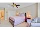 Bedroom with ceiling fan, accent chair with pillow, and a purple comforter on the bed at 1503 Pondside Ct, Summerville, SC 29485