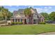 Beautiful two-story brick home with manicured lawn, mature landscaping, and a welcoming front entrance at 1503 Pondside Ct, Summerville, SC 29485