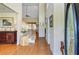 Bright foyer with hardwood floors, staircase, decorative table with floral arrangement, and soaring ceilings at 1503 Pondside Ct, Summerville, SC 29485