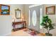 Elegant foyer with hardwood floors, decorative table, mirror, lamps, and a beautifully decorated front door at 1503 Pondside Ct, Summerville, SC 29485