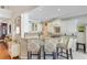 A kitchen features white cabinets, granite countertops, stainless steel appliances, and an island with bar seating at 1503 Pondside Ct, Summerville, SC 29485