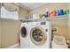 Laundry room featuring side-by-side washer and dryer with storage shelves and a window at 1503 Pondside Ct, Summerville, SC 29485