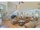 Bright living room with hardwood floors, vaulted ceilings, grand piano, and open concept to kitchen and stairway at 1503 Pondside Ct, Summerville, SC 29485