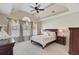 Bright primary bedroom suite featuring vaulted ceiling, fan, and large windows with curtains at 1503 Pondside Ct, Summerville, SC 29485
