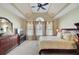 Spacious primary bedroom showcasing a ceiling fan, tray ceiling, and an abundance of natural light at 1503 Pondside Ct, Summerville, SC 29485