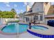 Inviting backyard pool and spa area, complemented by patio furniture and an umbrella for relaxation at 1503 Pondside Ct, Summerville, SC 29485