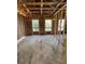 New construction bedroom with wood frame, subfloor, and windows overlooking a beautiful wooded area at 1519 John Fenwick Ln, Johns Island, SC 29455