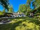 Expansive backyard with lush lawn, patio, firepit, and play structure at 1534 Kentwood Cir, Charleston, SC 29412