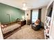 Charming Bedroom boasts a neutral color scheme, board and batten accent wall, carpet, and cute décor at 1534 Kentwood Cir, Charleston, SC 29412