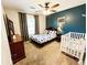 bedroom featuring carpet, dark blue accent wall, full bed, crib, and wood furnishings at 1534 Kentwood Cir, Charleston, SC 29412
