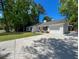 Side view of a charming white home with a garage, set on a well-manicured lawn and concrete driveway at 1534 Kentwood Cir, Charleston, SC 29412