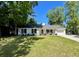 Charming single-story home with a well-manicured lawn, mature trees, and a welcoming front porch at 1534 Kentwood Cir, Charleston, SC 29412