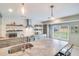 Bright kitchen features a large island, gray cabinets, subway tile backsplash, and stainless steel appliances at 1534 Kentwood Cir, Charleston, SC 29412