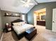 Spacious primary bedroom with vaulted ceiling, ensuite bathroom, carpet flooring, and neutral paint at 1534 Kentwood Cir, Charleston, SC 29412