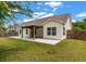 Backyard showcasing a pergola-covered patio, complemented by a well-kept lawn and fencing at 1610 Fishbone Dr, Johns Island, SC 29455