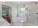 Luxurious bathroom with a soaking tub, glass shower, and marble tile at 1610 Fishbone Dr, Johns Island, SC 29455