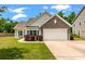 Charming single-Gathering home featuring a two-car garage, well-manicured lawn, and inviting curb appeal at 1610 Fishbone Dr, Johns Island, SC 29455