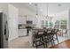 Kitchen with island bar seating flowing into the dining area with large windows offering natural light at 1610 Fishbone Dr, Johns Island, SC 29455