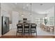 Bright kitchen with an island and bar seating flows into the adjacent dining area perfect for entertaining at 1610 Fishbone Dr, Johns Island, SC 29455