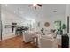 Open-concept living room showcases a smooth transition to the kitchen and dining area with hardwood floors at 1610 Fishbone Dr, Johns Island, SC 29455