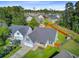 Aerial view showcasing the property's manicured lawn, neighborhood, and mature trees at 168 Cotillion Cres, Summerville, SC 29483