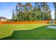 This large backyard features a green lawn, mature trees, and a wooden privacy fence at 168 Cotillion Cres, Summerville, SC 29483