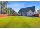 Large backyard featuring a green lawn, privacy fence, shed, and mature trees at 168 Cotillion Cres, Summerville, SC 29483