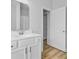 Stylish bathroom with a vanity, framed mirror, white cabinets, and wood-look flooring at 168 Cotillion Cres, Summerville, SC 29483