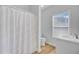 Bright bathroom featuring a shower with curtain, white vanity, and wood-look flooring at 168 Cotillion Cres, Summerville, SC 29483