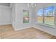 Bright dining room with beautiful wood floors, large windows, and modern chandelier at 168 Cotillion Cres, Summerville, SC 29483