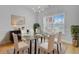 Elegant dining room with modern chandelier, glass table, and ample natural light at 168 Cotillion Cres, Summerville, SC 29483