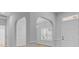 A well-lit entryway with hardwood floors and arched doorways leading to other rooms at 168 Cotillion Cres, Summerville, SC 29483