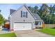 Gray home with a two-car garage, beautiful lawn, and inviting front porch at 168 Cotillion Cres, Summerville, SC 29483