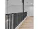 Second floor hallway with a black railing and wood-look floors at 168 Cotillion Cres, Summerville, SC 29483