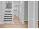 Hallway with stairs, white trim and walls, wood-look floors, and an arched entryway at 168 Cotillion Cres, Summerville, SC 29483