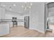 Spacious kitchen with stainless steel appliances, white cabinets, and modern lighting at 168 Cotillion Cres, Summerville, SC 29483