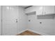 A modern laundry room with white cabinets, a door leading to the exterior, and vinyl floors at 168 Cotillion Cres, Summerville, SC 29483