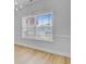 Bright living room featuring light wood floors, white trim, and a large window for natural light at 168 Cotillion Cres, Summerville, SC 29483