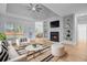 Inviting living room with a fireplace, built-in shelving, and an adjacent dining area for seamless entertaining at 168 Cotillion Cres, Summerville, SC 29483