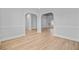 An open-concept living room with neutral paint, light wood flooring, and elegant architectural details at 168 Cotillion Cres, Summerville, SC 29483