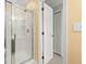 Bright bathroom featuring a glass-enclosed shower with chrome fixtures and a built-in shelving unit at 1708 Waterbrook Dr, Charleston, SC 29414