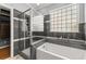 Modern bathroom featuring glass shower, tub, and tiled walls at 1708 Waterbrook Dr, Charleston, SC 29414
