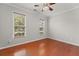 Bright bedroom featuring hardwood floors, ceiling fan, and natural light from two windows at 1708 Waterbrook Dr, Charleston, SC 29414