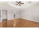 Spacious bedroom featuring tray ceiling, fan, and hardwood floors at 1708 Waterbrook Dr, Charleston, SC 29414