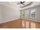 Spacious bedroom featuring tray ceiling, fan, and hardwood floors at 1708 Waterbrook Dr, Charleston, SC 29414